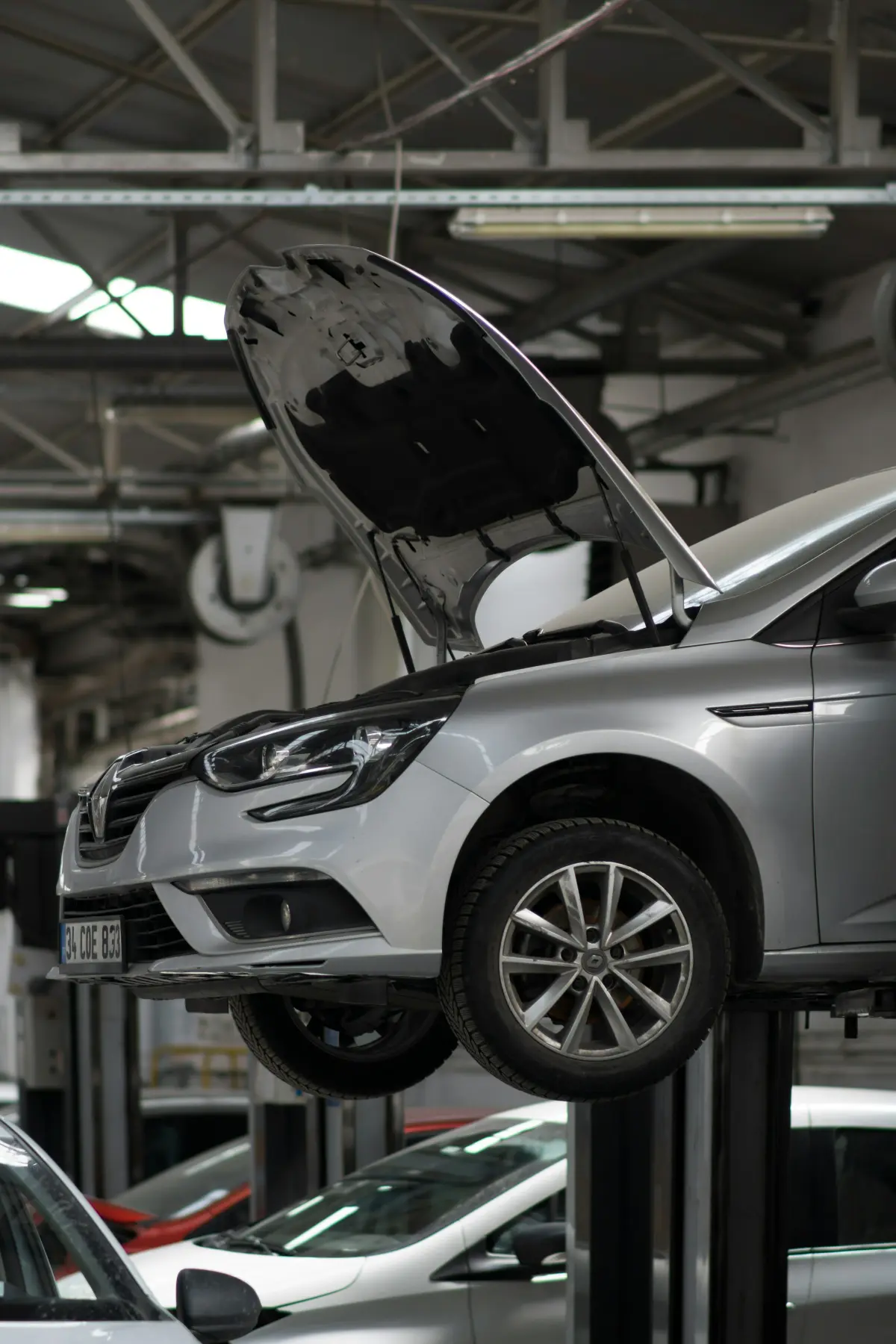 A car raised on a lift in the service bay